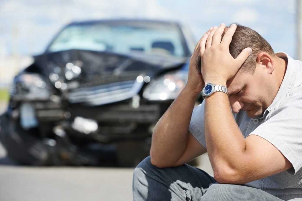 Adult upset driver man in front of automobile crash car collision accident in city road